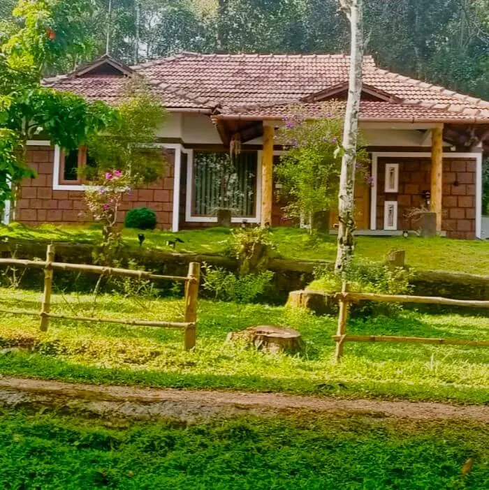 The homestay building across the lawn behind a low wooden fence