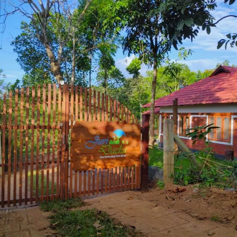 The wooden entrance gate carrying the homestay signboard