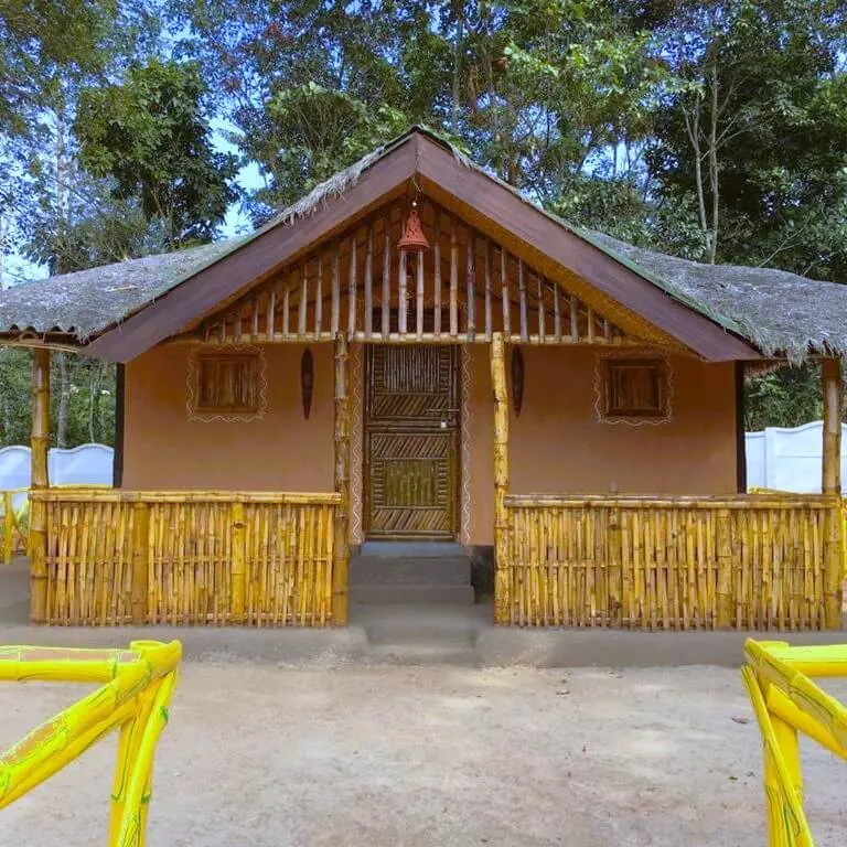 The bamboo hut, with a yellow bamboo railing along its veranda