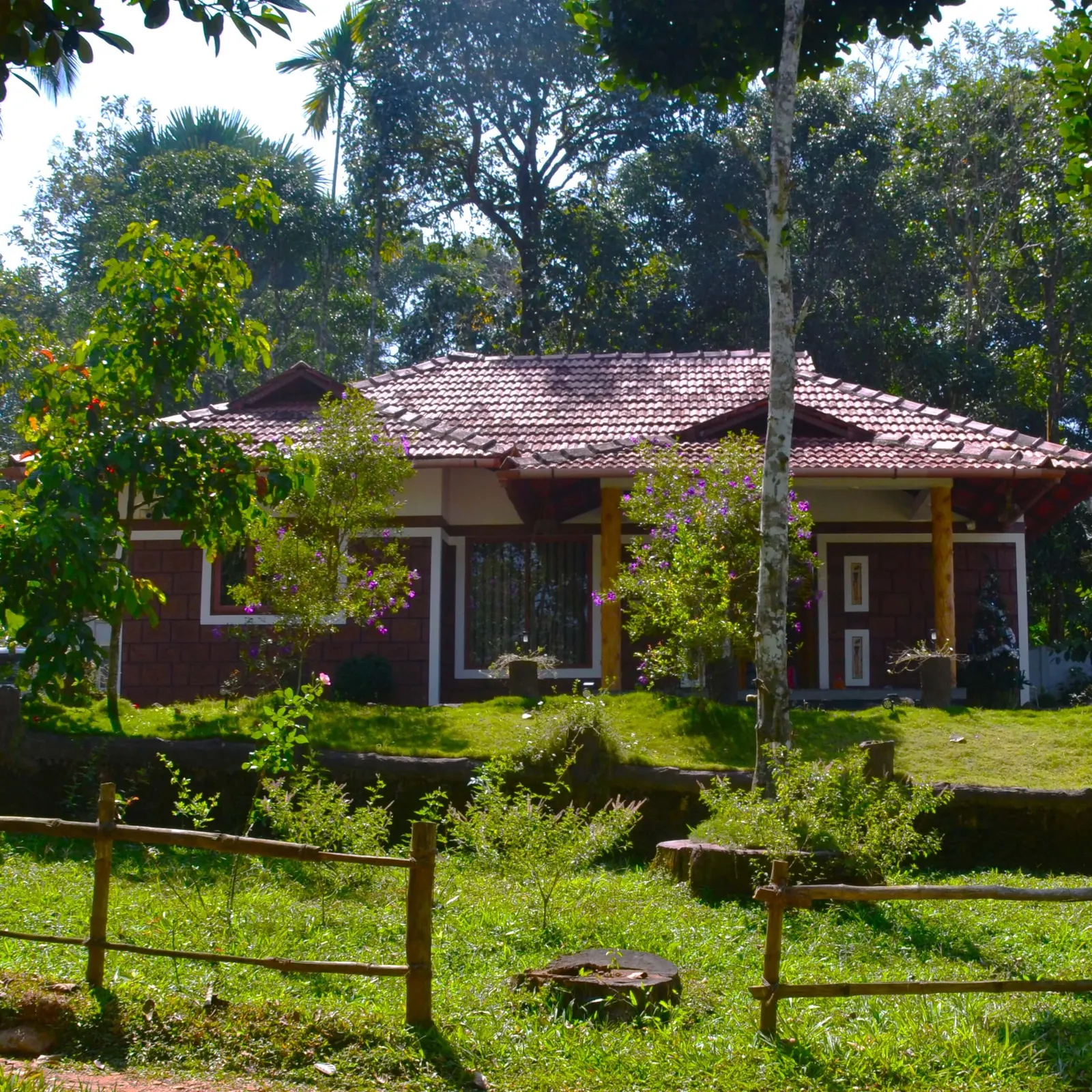 The homestay building behind a wooden post-and-rail fence