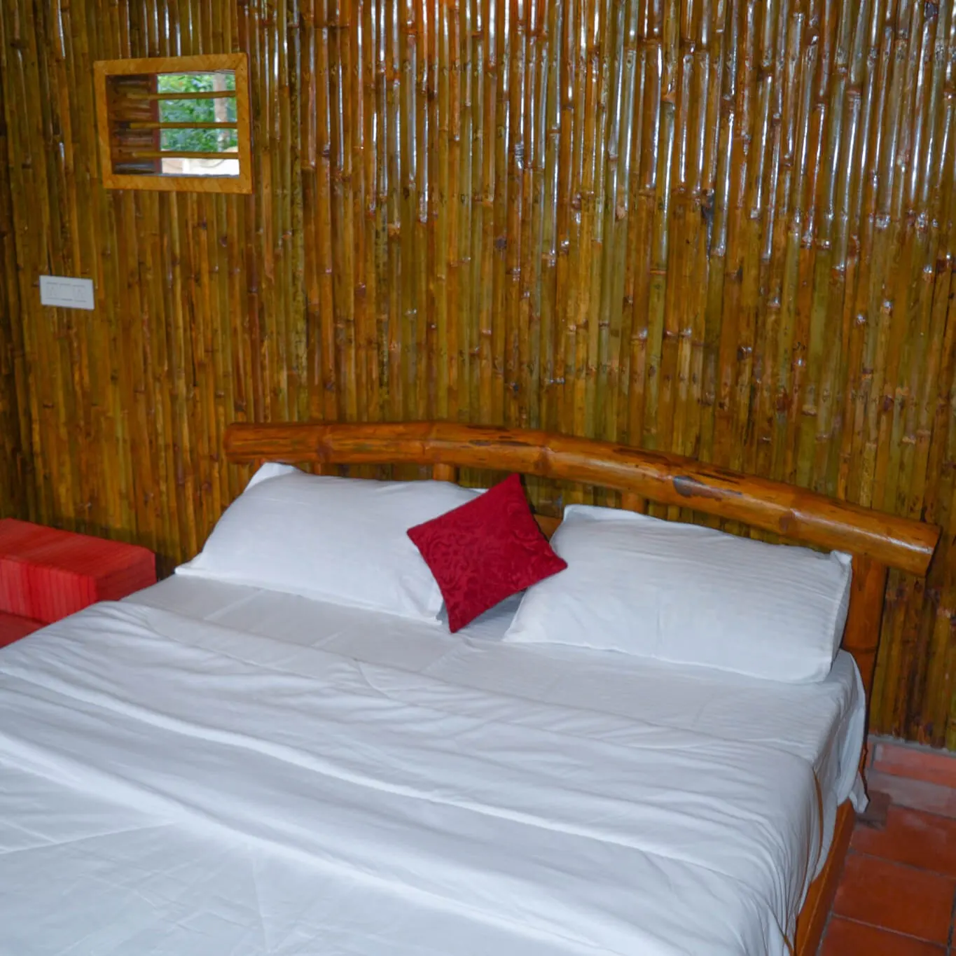 The bedroom inside Vanshah, the bamboo hut, panelled in bamboo behind the bed