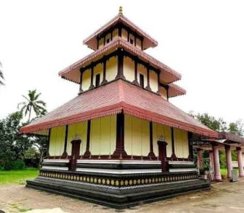 The tiered, tile-roofed temple with its carved timber gables, seen from the corner across the grass